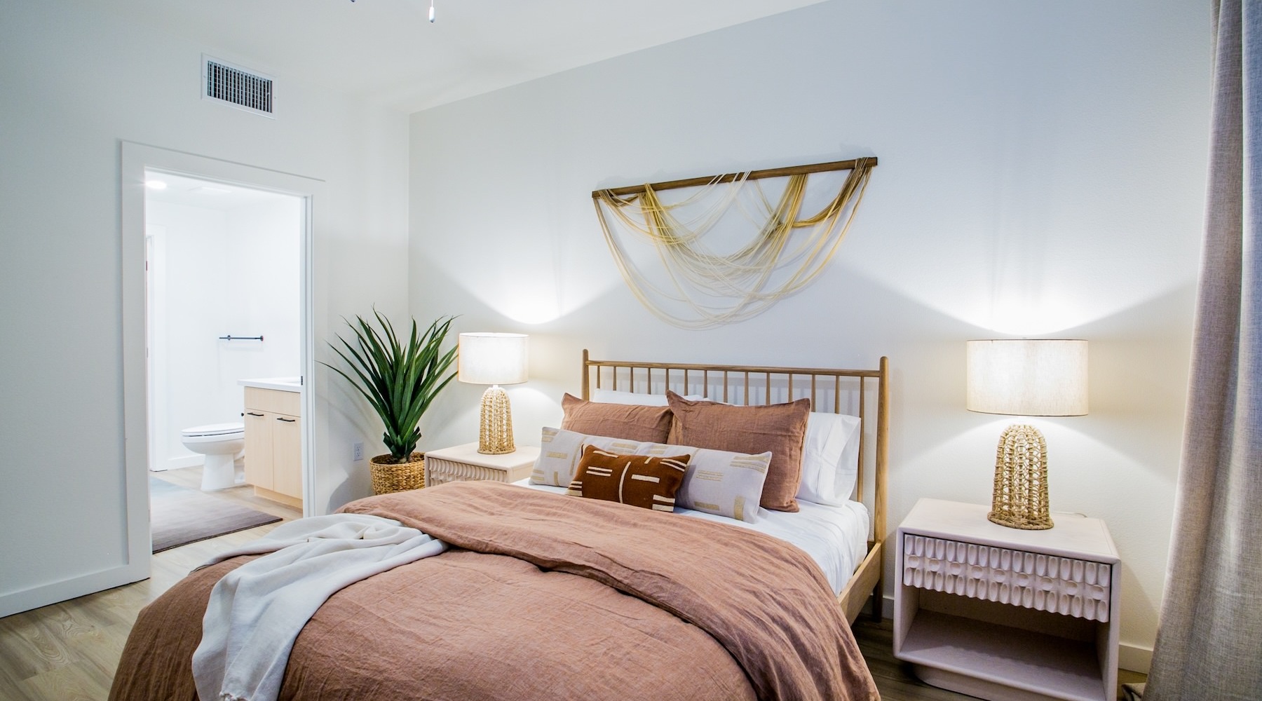 Beautiful bedrooms to fit every need a bedroom with a nightstand, dresser and lamps