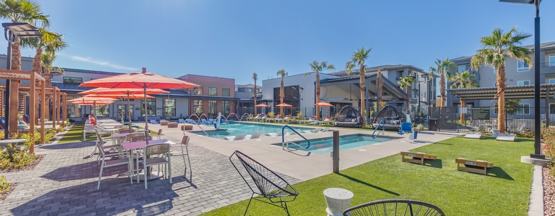 pool with lounge seating at Alma Henderson Apartments