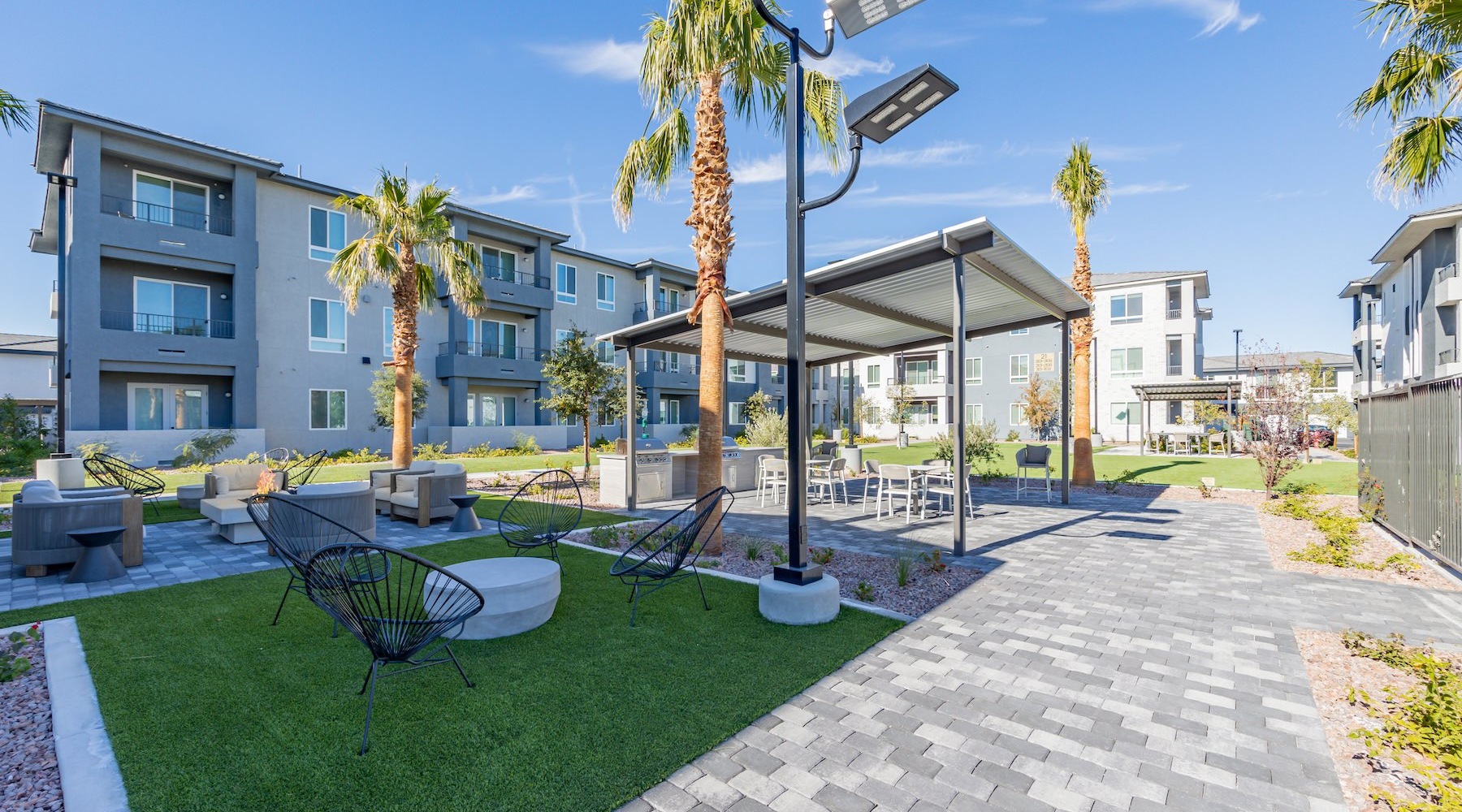 State-of-the-art amenities a courtyard with tables, chairs and trees