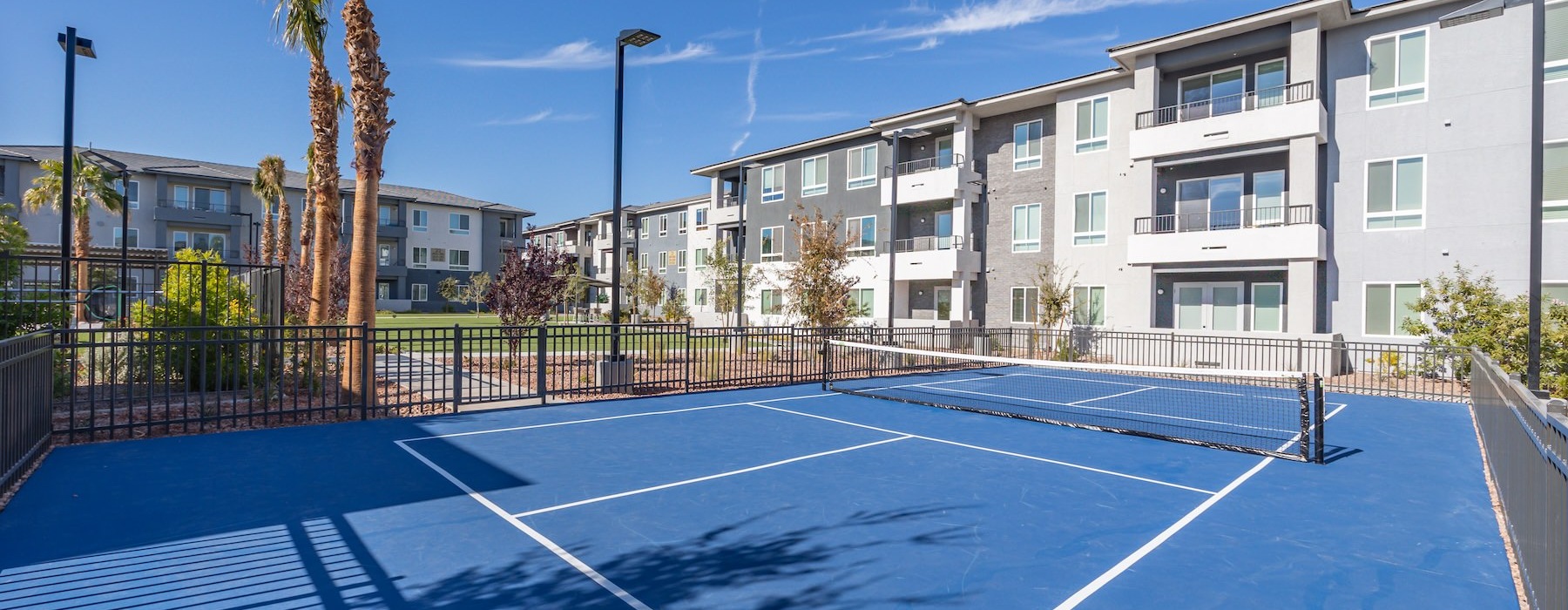 a tennis court in front of a building