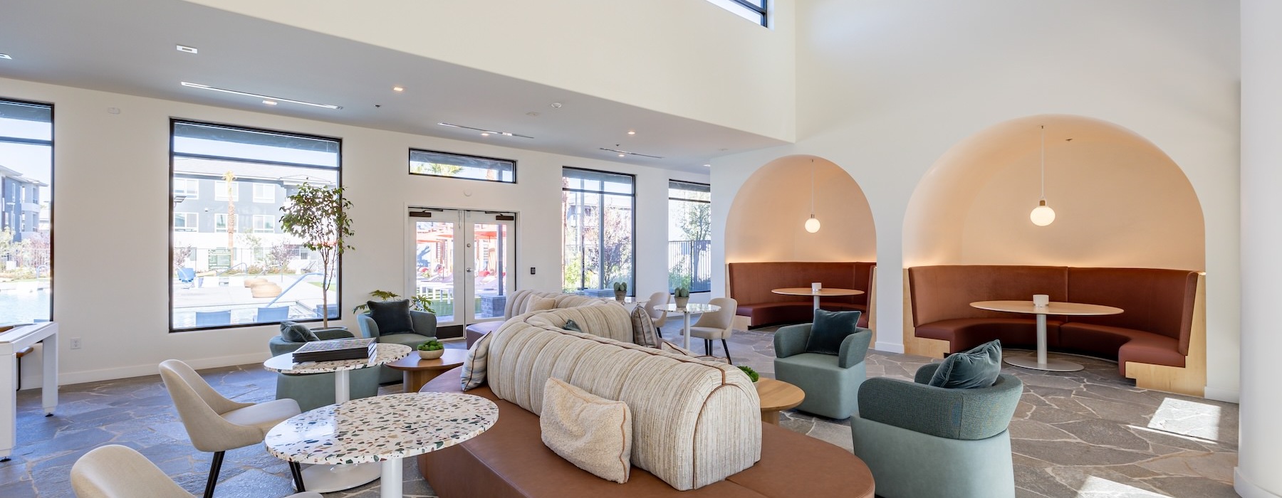 a clubhouse room with a couch and chairs
