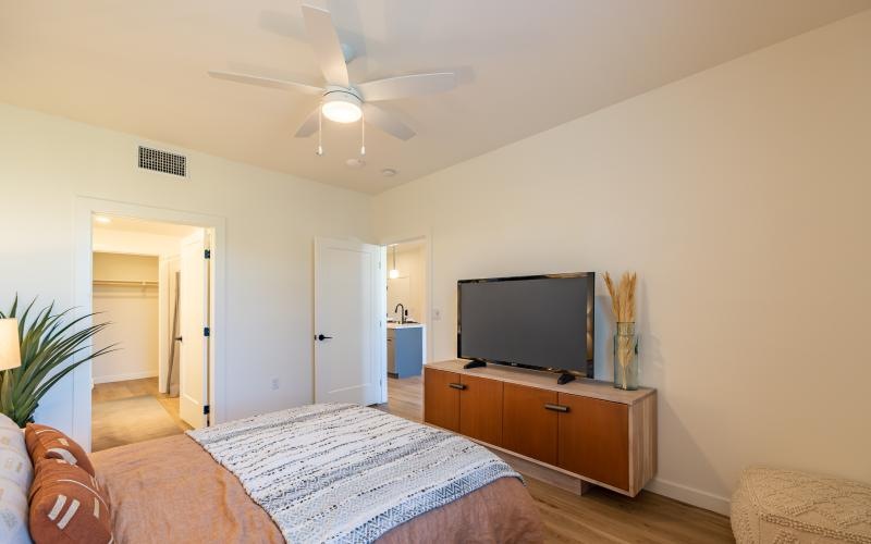 a bedroom with a tv and a bed