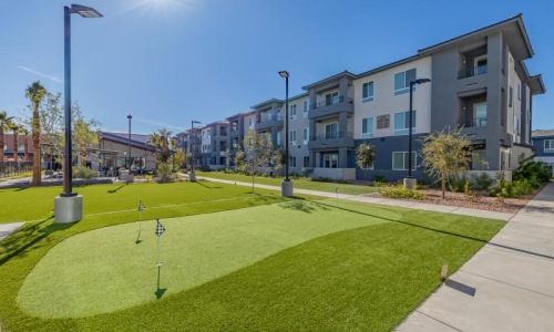 Cutting-edge amenities at your fingertips a building with a lawn and trees